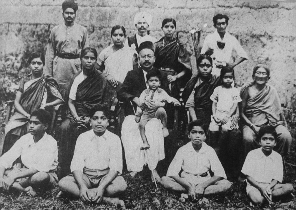 With family 1931, sitting on floor (from l to r): Thiappanna, Venkateswara, Radhakrishna and Ramachandra. Sitting on chairs (from l to r): Sanjeevamma, Chellamma (father’s sister), father C.D. Naidu (with grandson on his lap), mother Laxmikanthamma (with Neelavati on her lap) and mother’s grandmother. Standing (from l to r): Policeman in attendance to C.D. Naidu, Narasamma, orderly in attendance to C.D. Naidu, Sakuntalammma and a poor boy staying with the family