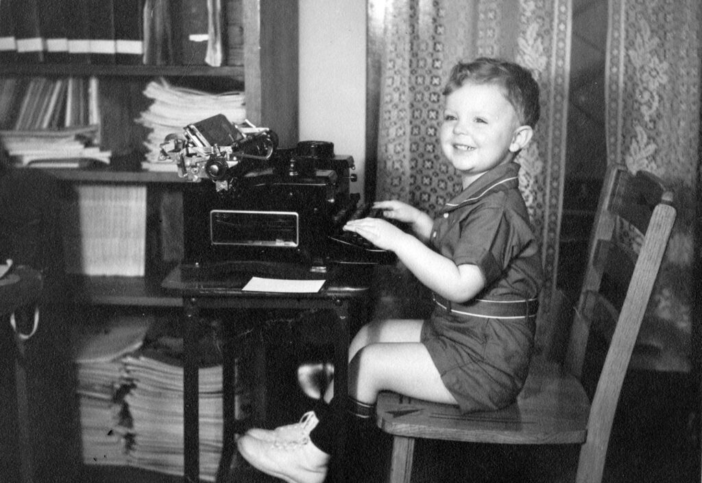 At his parents' typewriter at age 3; evident is an early fascination for keyboards; 1941