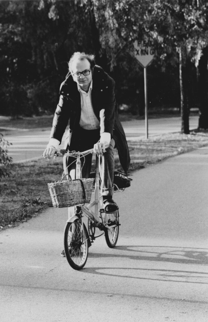 Riding a bicycle with shock absorbers, invented by Alex Moulton; 1965