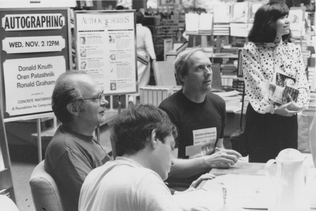 (L to R) Don, Oren Patashnik, Ron Graham, and Fan Chung at a book-signing party to inaugurate the publication of  Concrete Mathematics; 1988