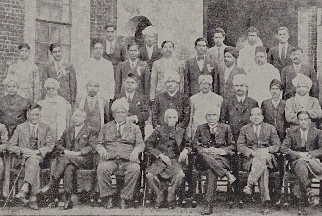 A 1928 photo from the conference of the Indian Mathematical Society held in Nagpur. Sarvadaman Chowla is in the last row third from the right, and S.S. Pillai is second from the right. Chowla's father (G.S. Chowla) is seated left most. V. Ramaswami Aiyer, the founder of the Indian Mathematical Society is seen seated third from the left, and C.V. Raman is fifth from the left.