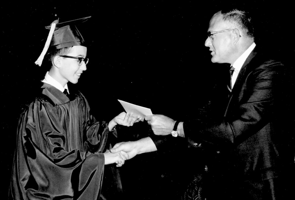 Receiving his high school diploma at the age of 13.
