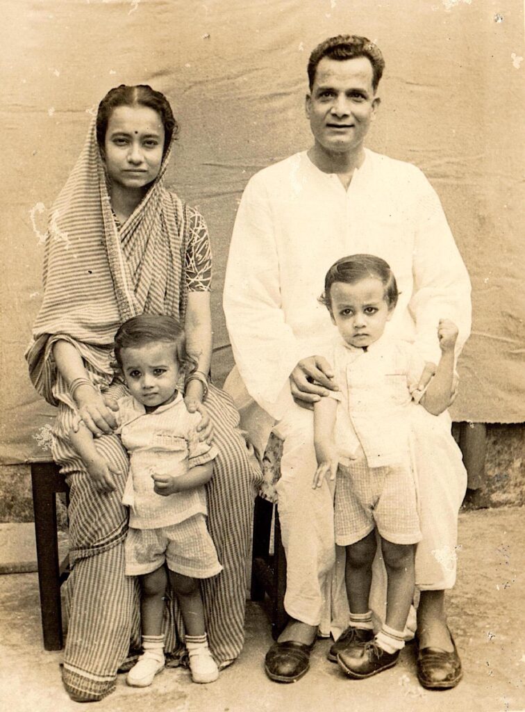 An early photo with parents and younger brother.