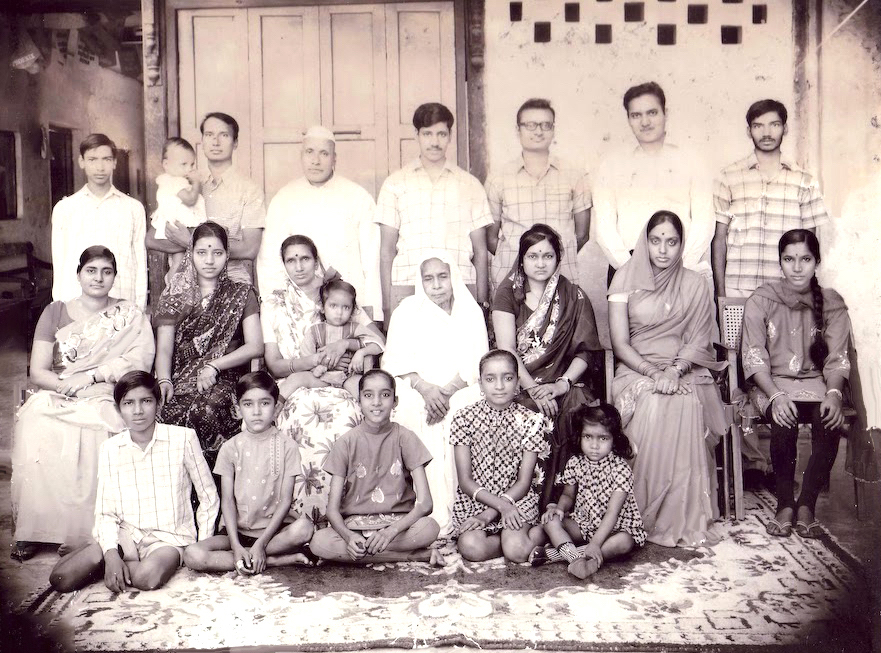 A family photo from 1972. Sitting on the floor (L to R): Dipendra Prasad, Sunil Kumar, Kiran Kedia, Shashi Adukia, Suman Bansal. Sitting on Chairs (L to R): Kanak Agrawal (a cousin of ours), Indu Prasad,  Lakshmi Devi with Archana Prasad in arm, Anardeyi Devi, Shakuntala Devi, Shakuntala Devi (Yes, same name!), Padma Modi. Standing (L to R): Pawan Kumar, Gopal Prasad with Anoop Prasad in arm, Ramkrishna Prasad, Anand Prasad, Rajendra Prasad, Shyam Sunder Prasad, Shrawan Kumar.  Gopal Prasad family 