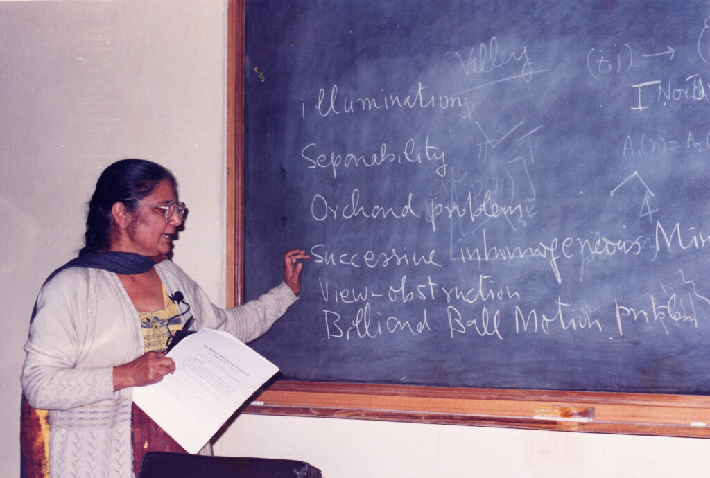 Giving a talk on her work.