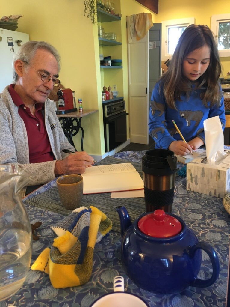 Writing diary with granddaughter Naia, Westport 2022.